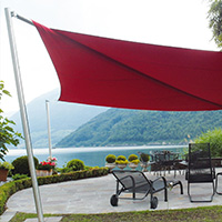 Rotes vollautomatisches Sonnensegel am Wasser